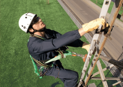 mann i høyspentmast